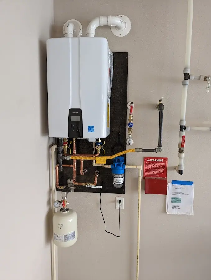 Professional plumber installing copper piping in a Kingston home
